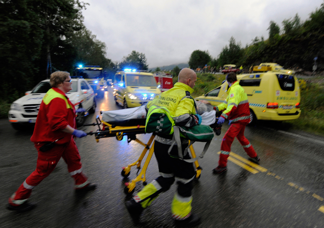 Rescue personnel push an injured victim away from the camp site of in Uoteya, where a gunman dressed in police uniform killed at least 85 people on July 23, 2011. (REUTERS/Morten Edvardsen/Scanpix)